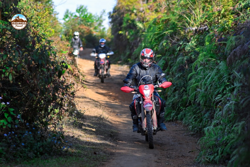 Foreign tourists riding motorbikes safely in Vietnam.